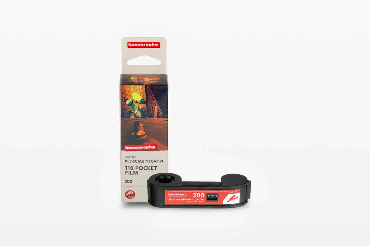 Lomography Lobster Redscale 110 ISO 200 film packaging with black reel, ideal for vibrant sun-kissed photography.