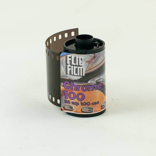 Flic Film Chrome 100 35mm slide film canister with exposed film strip, optimized for E6 development.