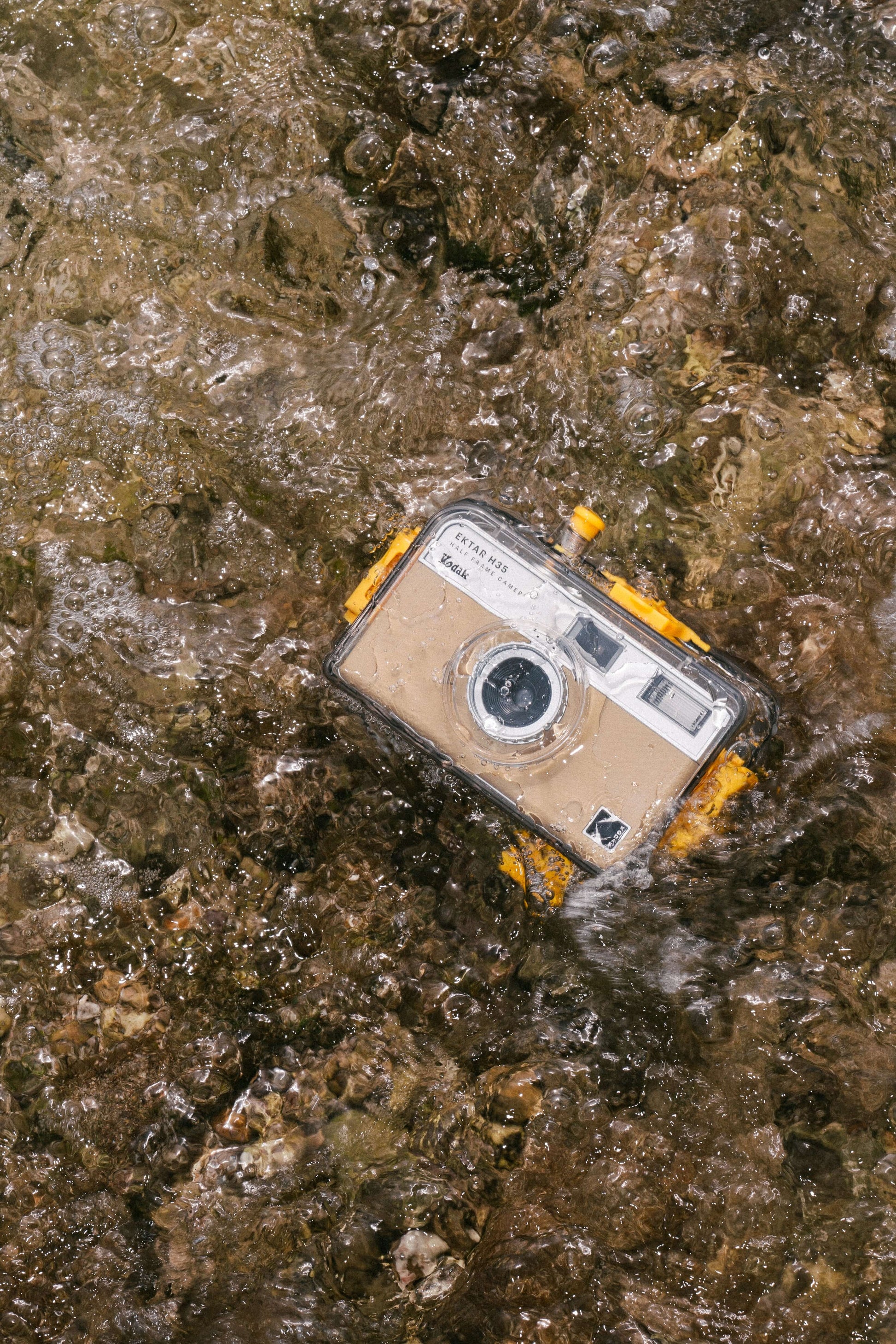 Kodak Reto Ektar H35N waterproof case without camera submerged in water, perfect for underwater photography up to 16 feet.