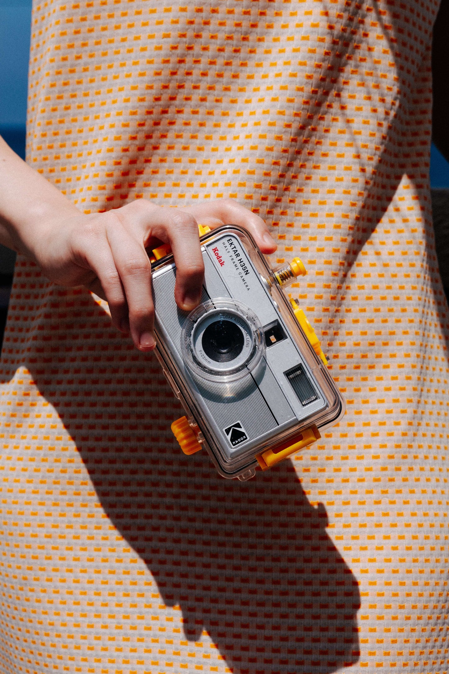 Person holding Kodak Reto Ektar H35N underwater case for half frame film camera