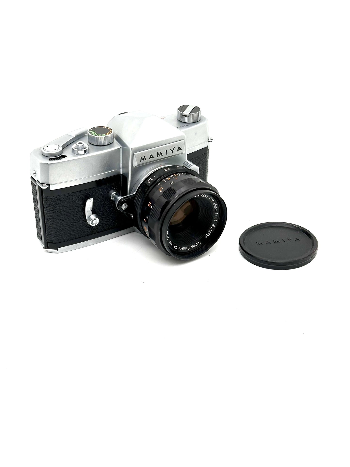 Vintage Mamiya film camera with lens cap on a white background