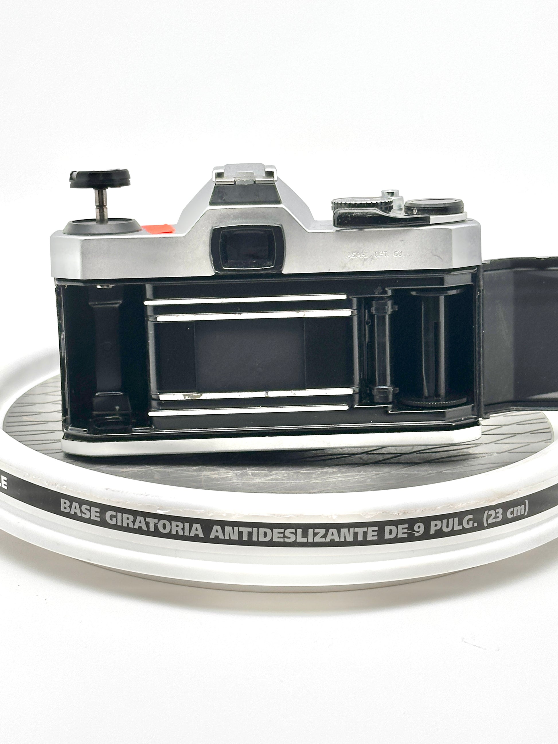 Back view of Japanese Asahi Pentax K1000 black 35mm film camera showcasing the film compartment and winding mechanism.