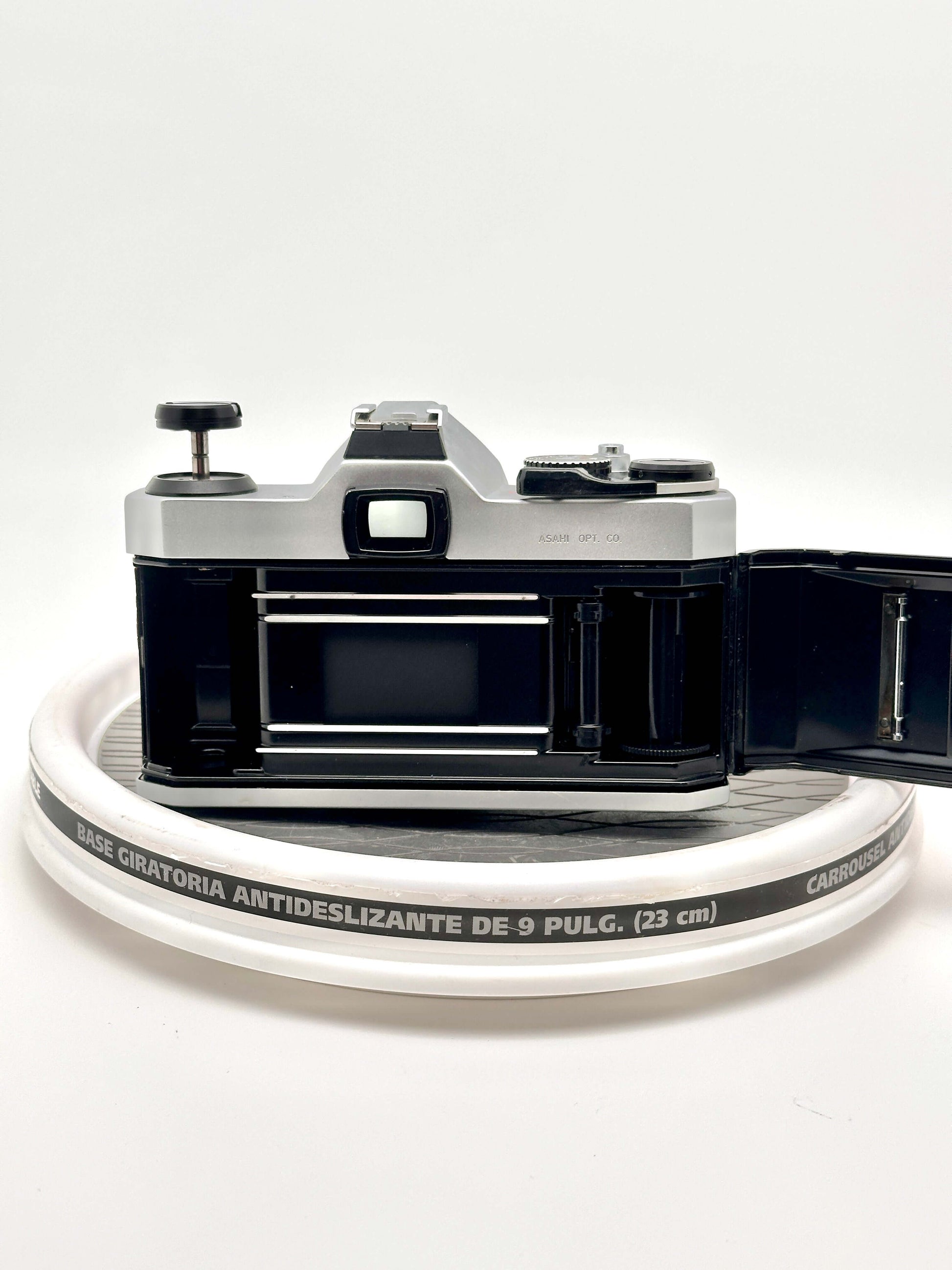 Rear view of a Japanese Asahi Pentax K1000 35mm film camera showing the open back and film compartment.