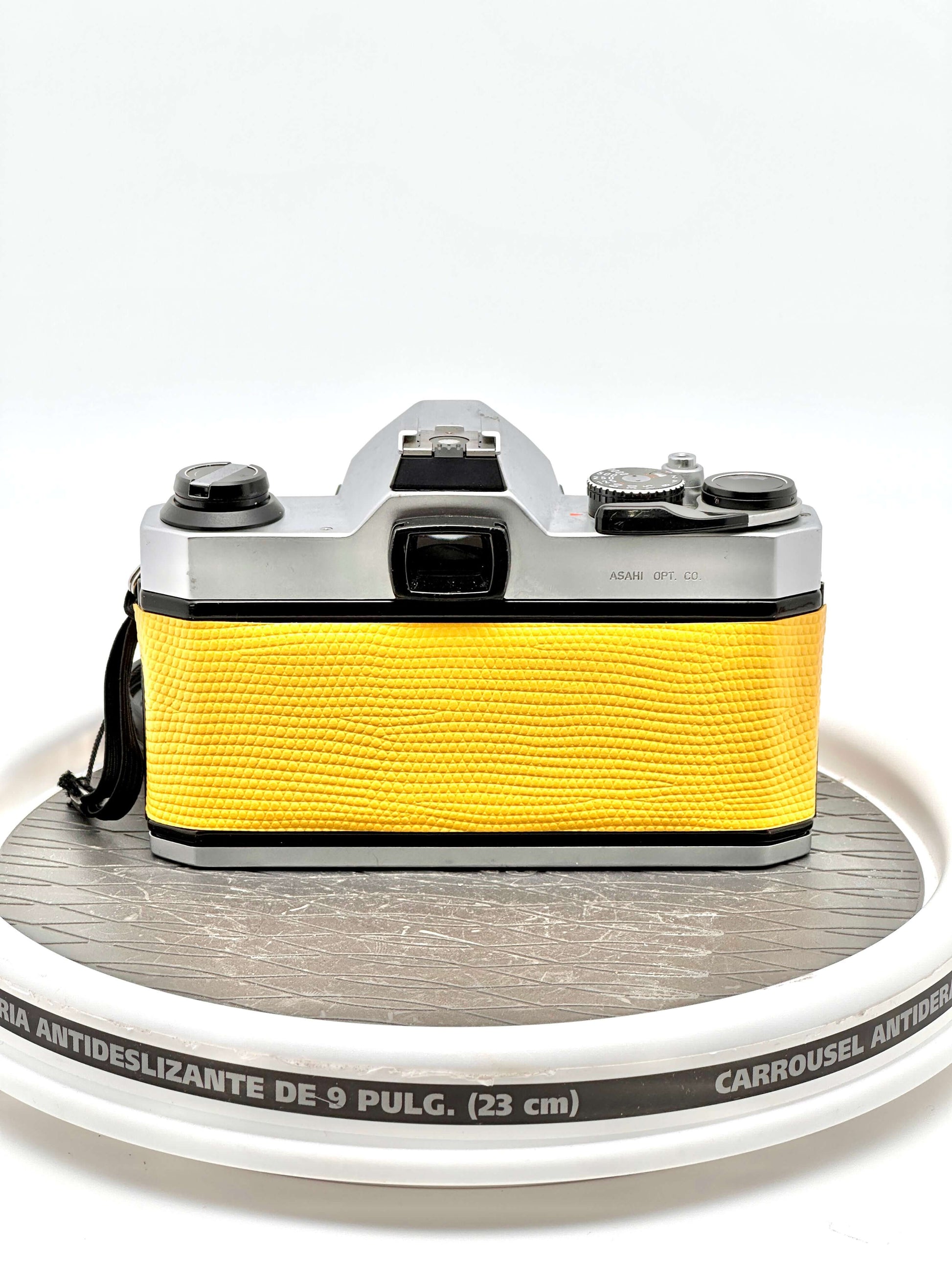 Japanese Asahi Pentax K1000 used 35mm film camera with vibrant yellow case, showcasing its classic design and reliable build.