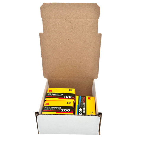 Yellow kodacolor color negative film cartridges in a white cardboard box.