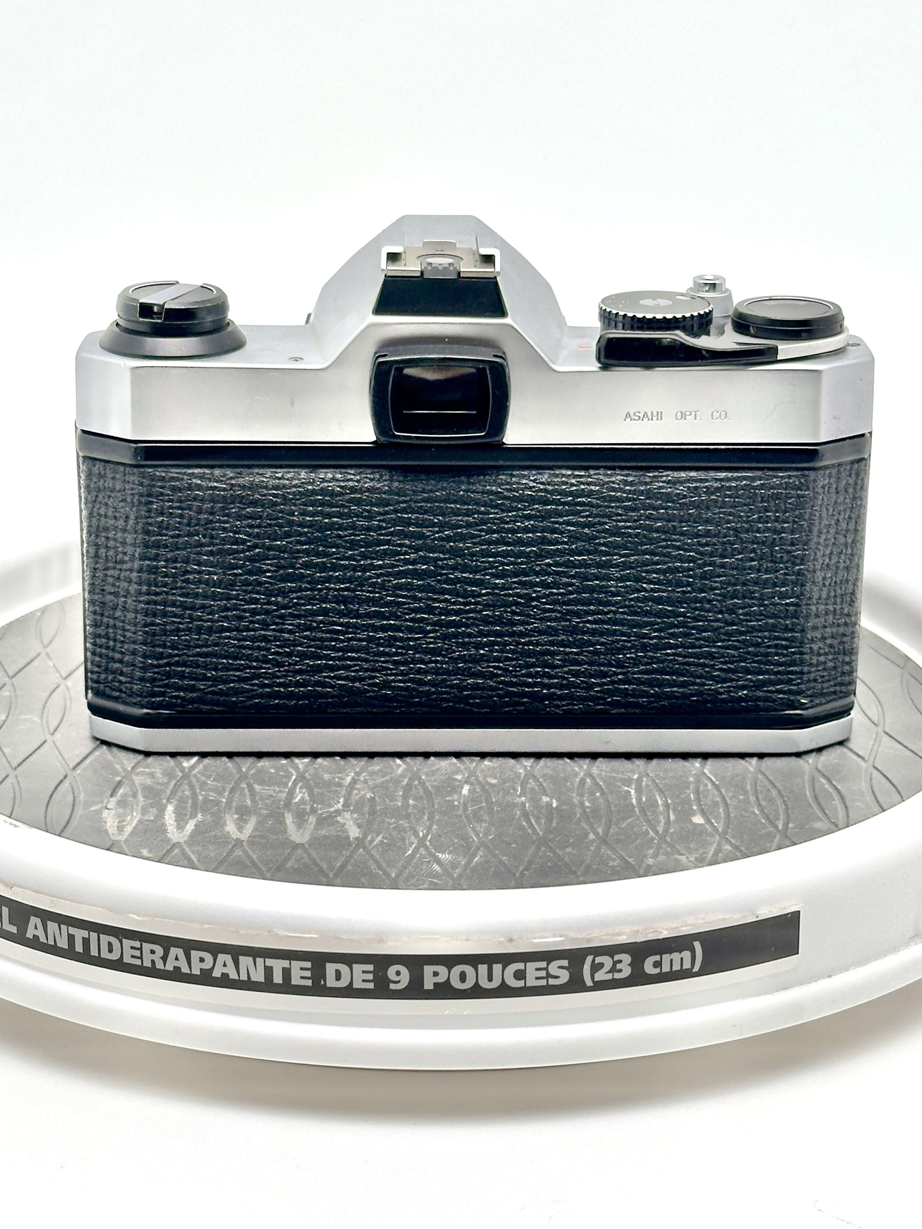Back view of used Japanese Asahi Pentax K1000 black 35mm film camera showing textured grip and controls.