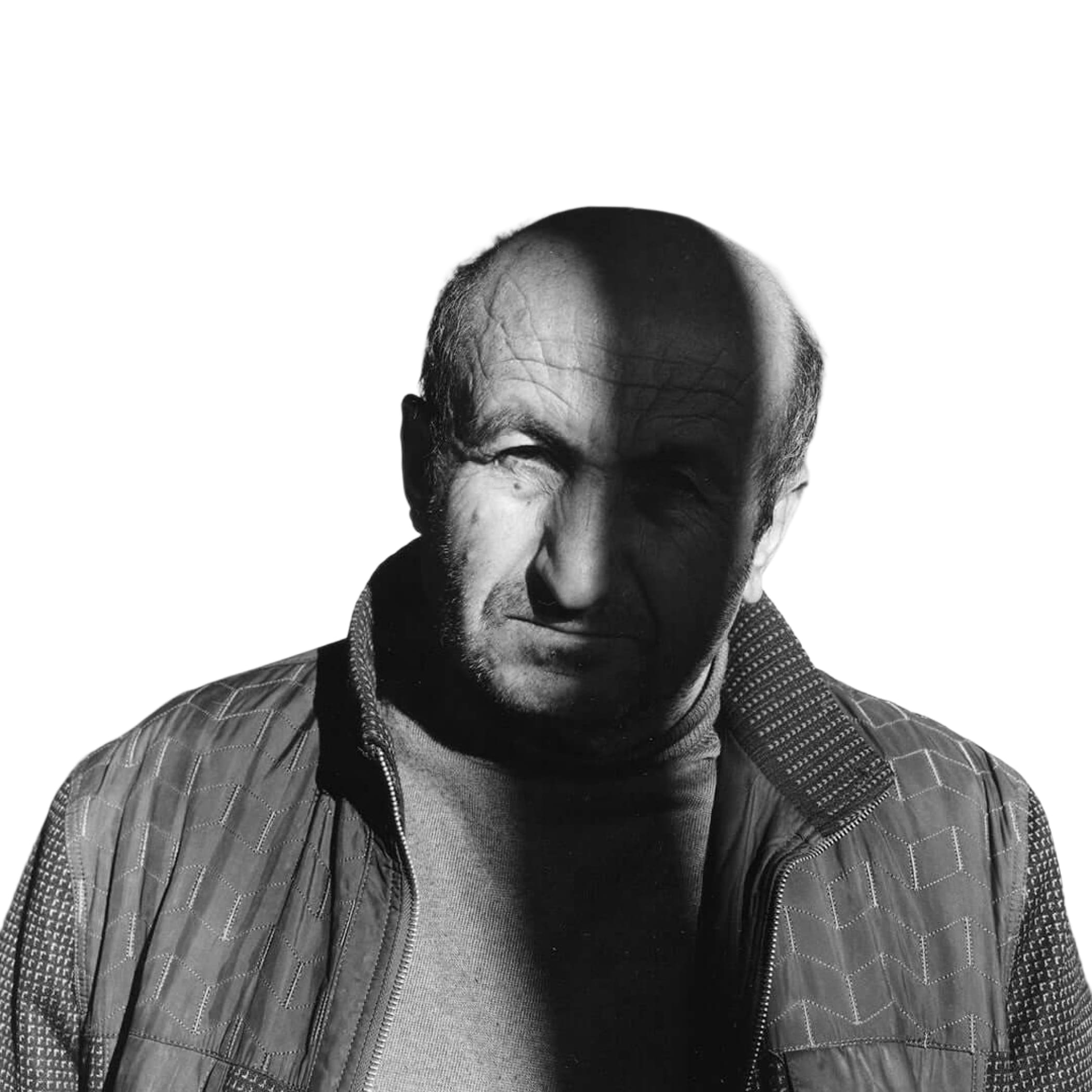 A man wearing a quilted jacket with geometric stitching patterns.