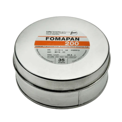 Silver cylindrical canister of fomapan 200 black and white negative film, labeled with orange and black text.