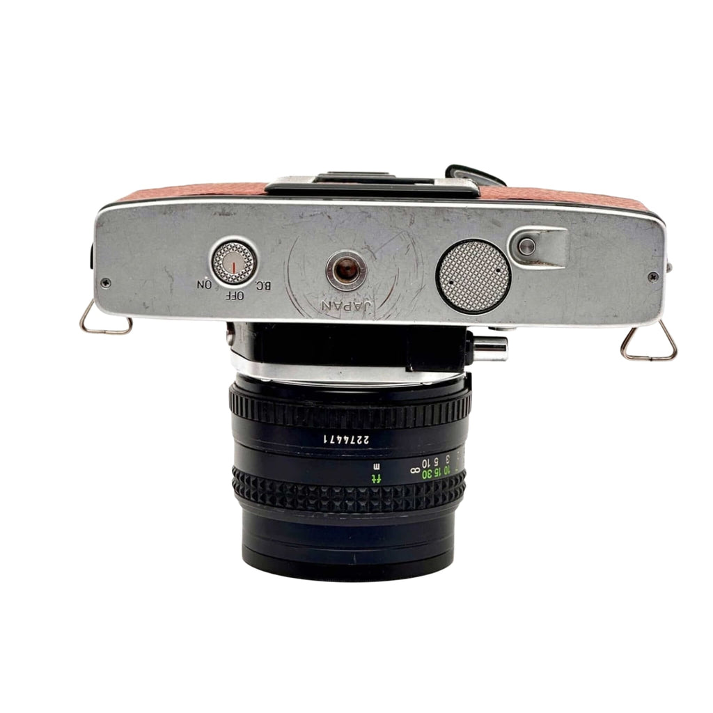 Silver-bodied vintage camera with a brown leather top and a black lens mounted on it.