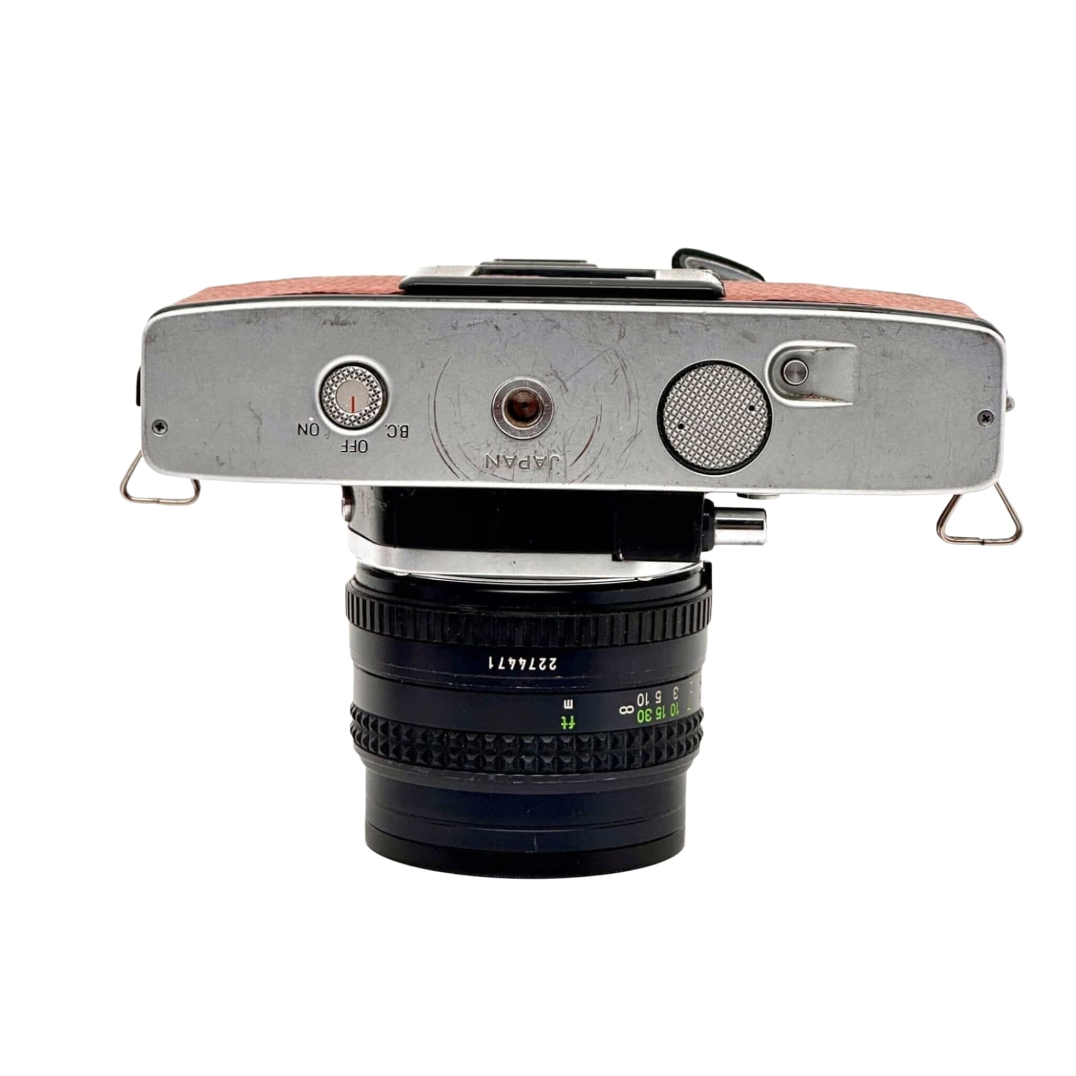 Silver-bodied vintage camera with a brown leather top and a black lens mounted on it.