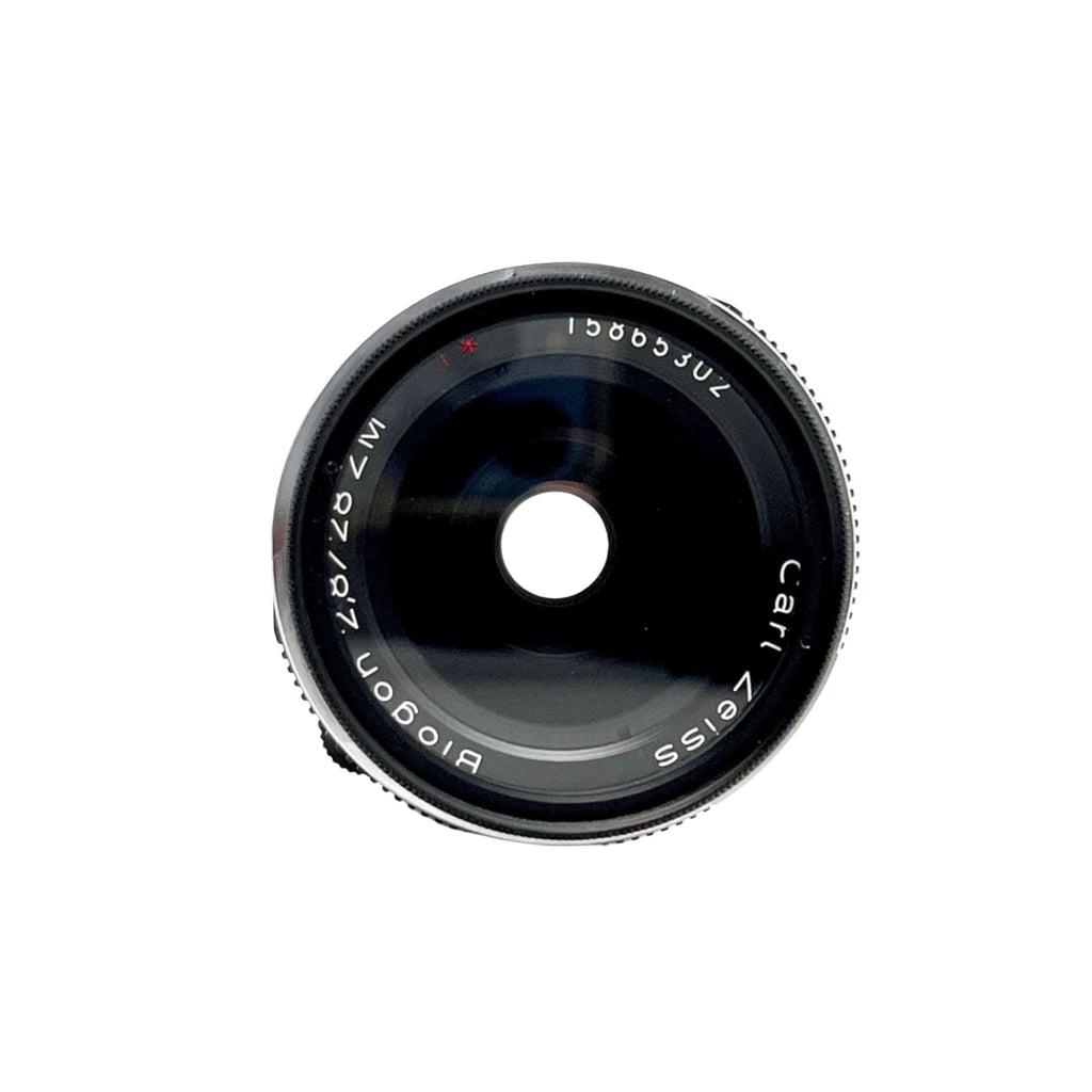 Black carl zeiss biogon 87mm f/2.0 lens with a sleek, metallic finish and engraved markings on the barrel.