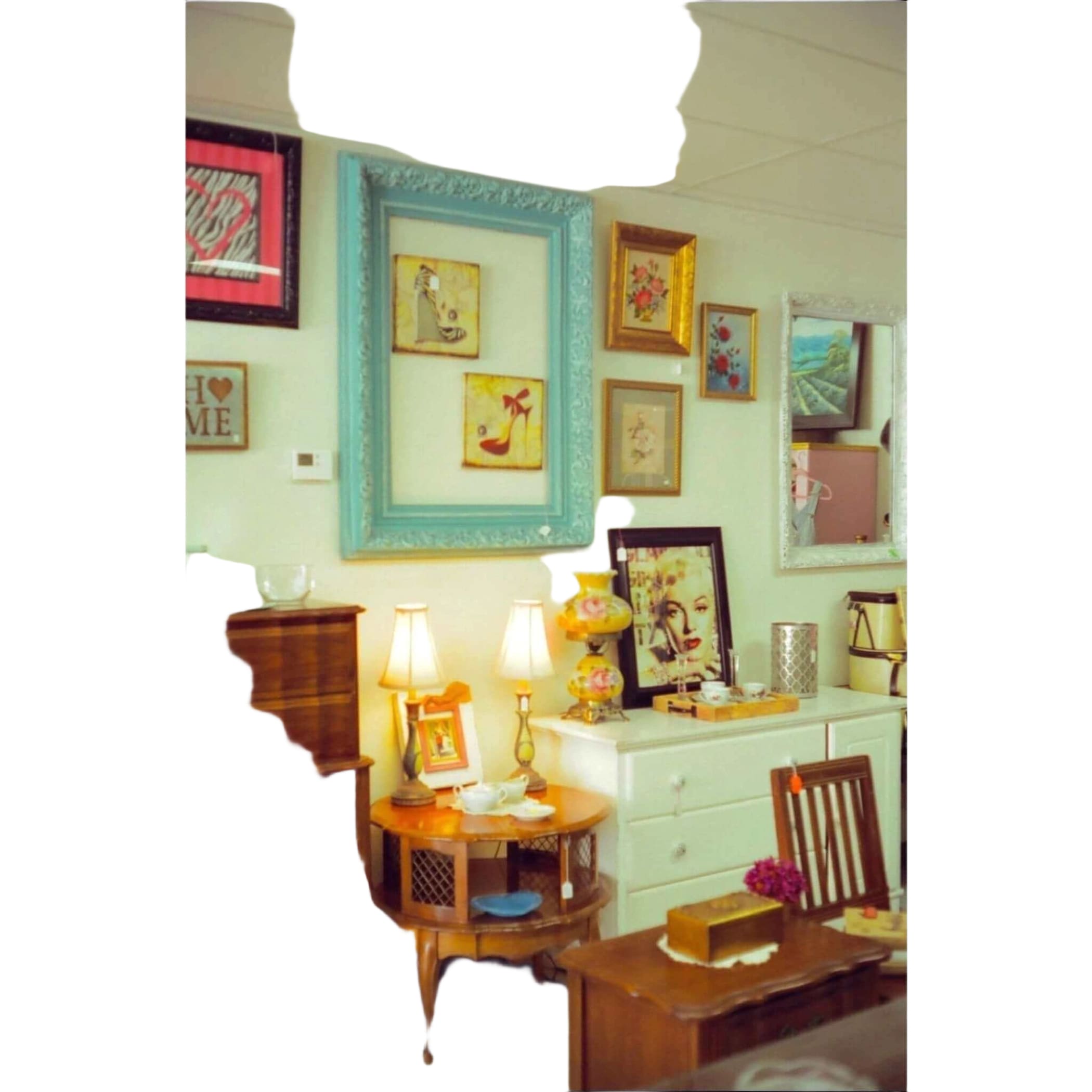 A decorative turquoise picture frame with an ornate, carved design.