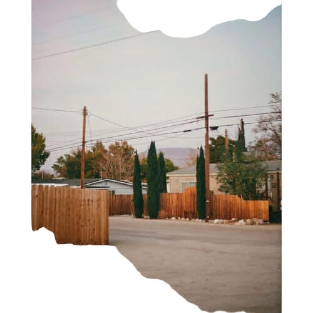 A weathered wooden fence with vertical slats, painted in a faded brown hue.