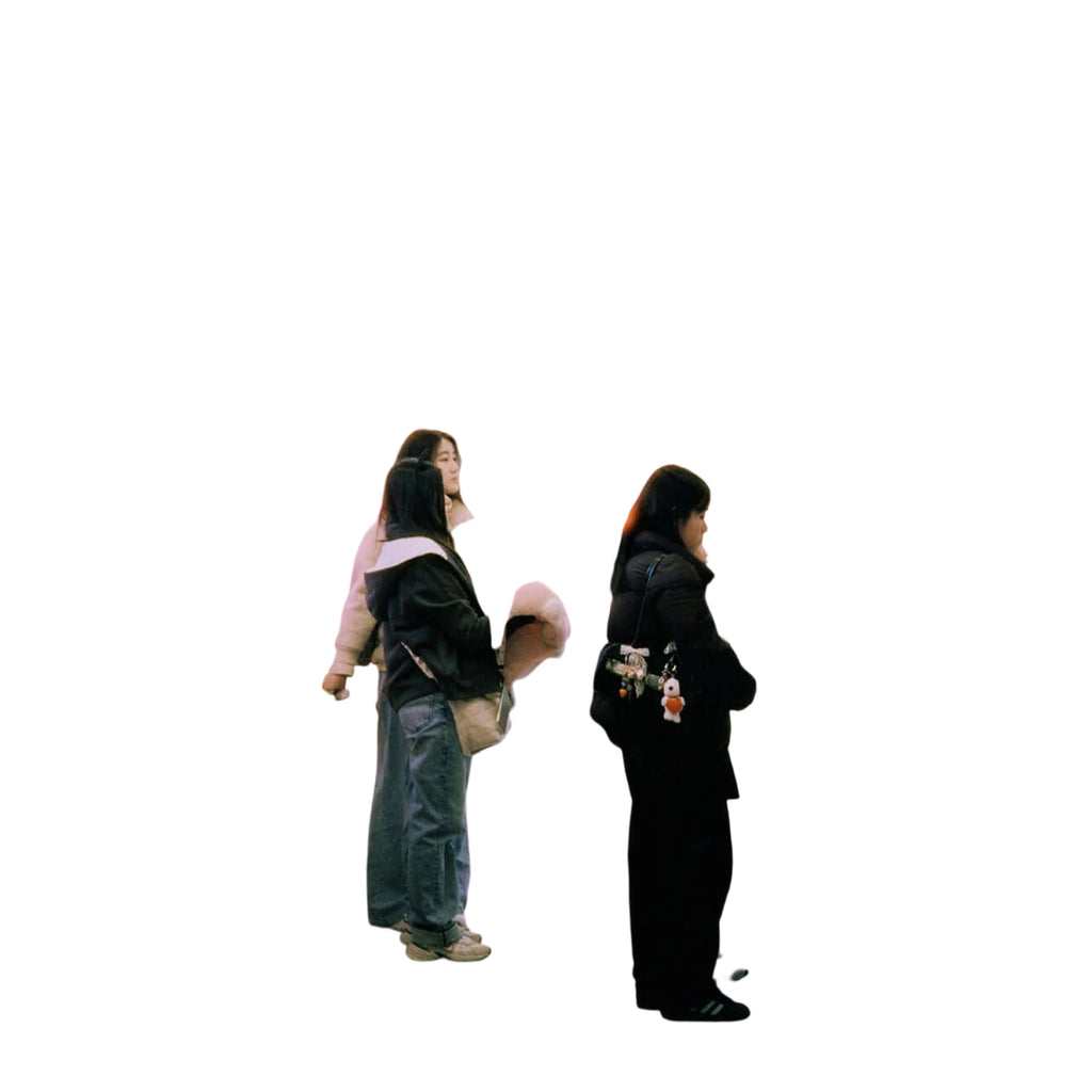 The image shows a hallway with people browsing merchandise, but no single main object is clearly identifiable as the focus of the scene.