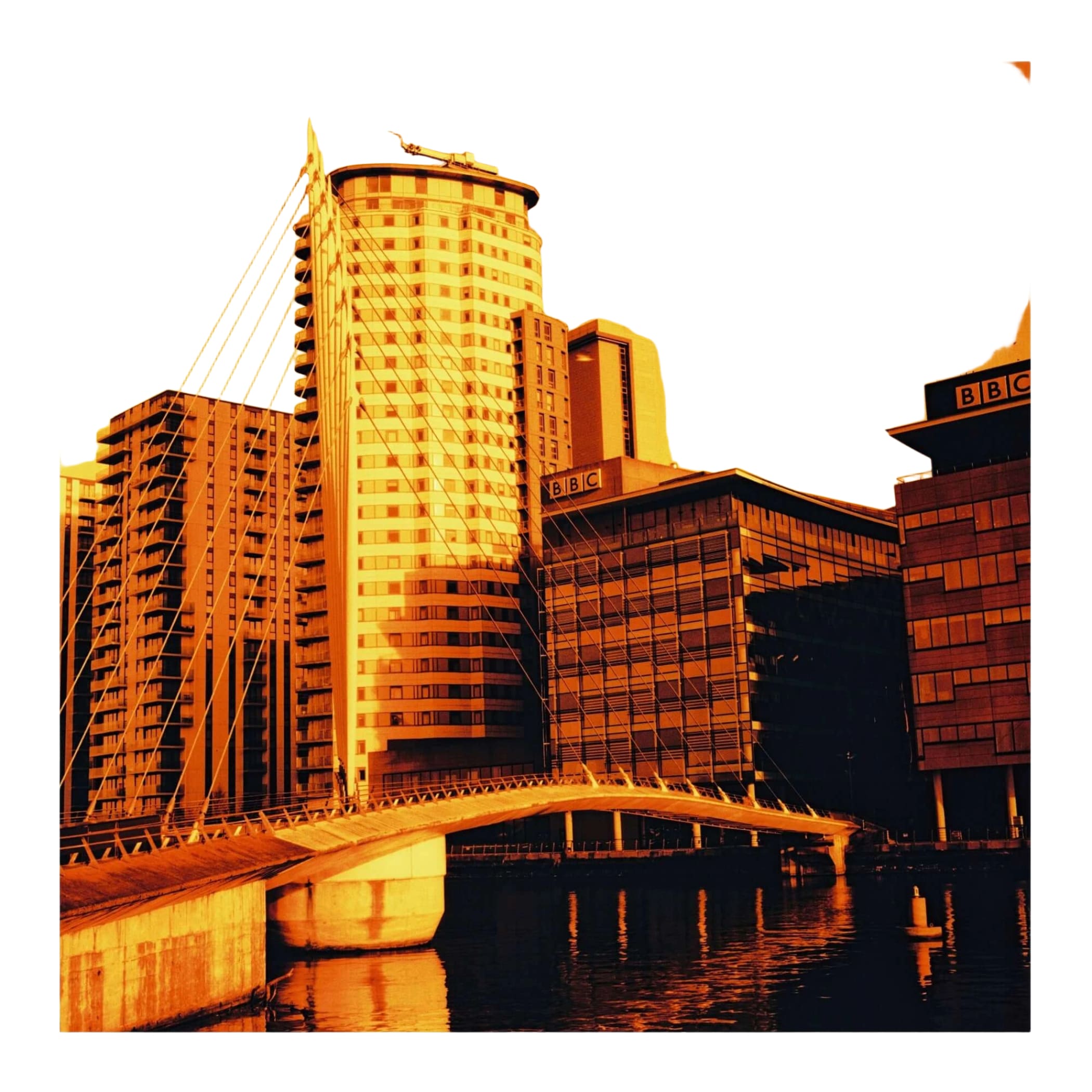 Tall cylindrical building with a curved top and numerous windows, featuring bbc signage on adjacent structures.