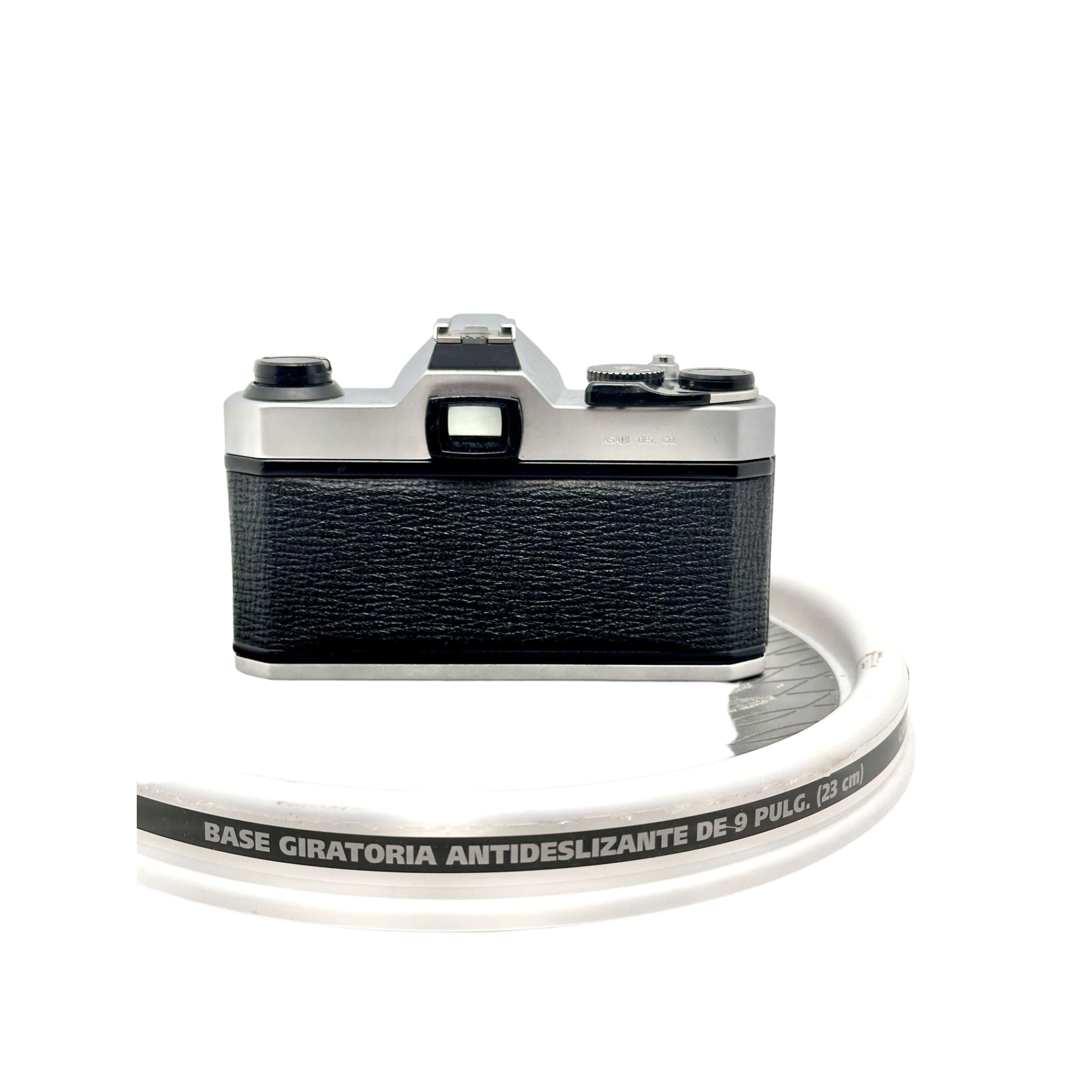 Silver and black canon ae-1 film camera with textured leather grip.