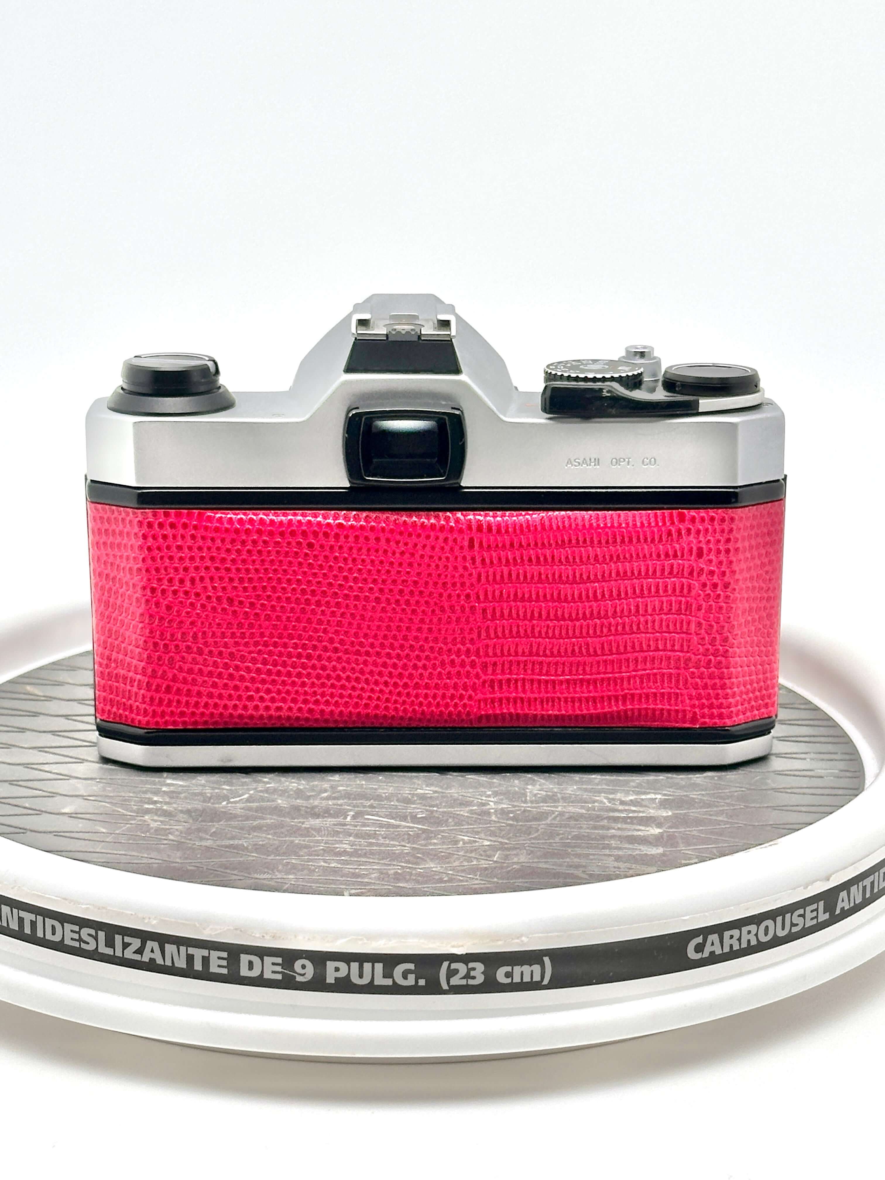 Japanese Pentax K1000 camera in red, showcasing its unique design and robust build, perfect for photography enthusiasts.