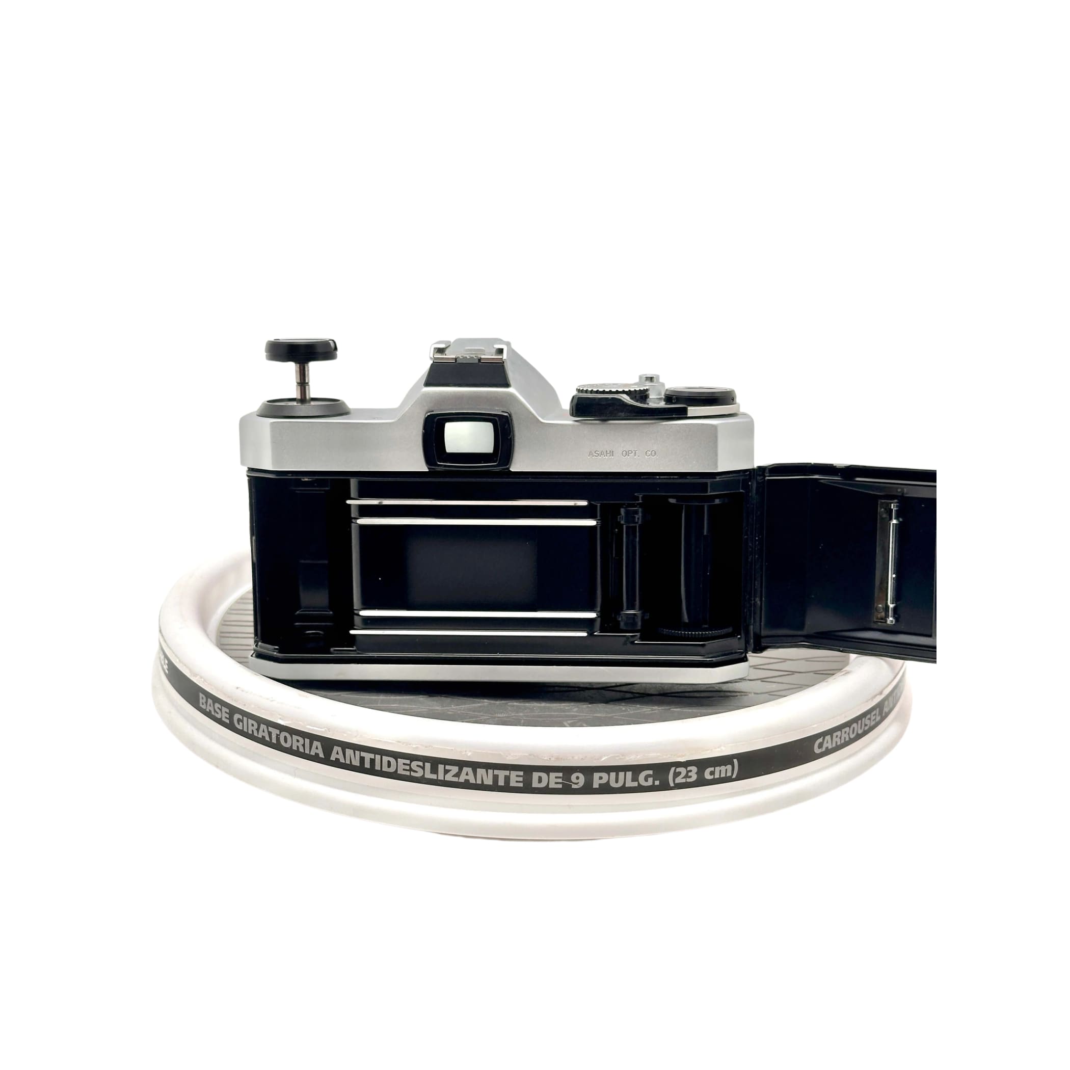 Silver-bodied canon ae-1 film camera with black accents and a visible shutter release button.