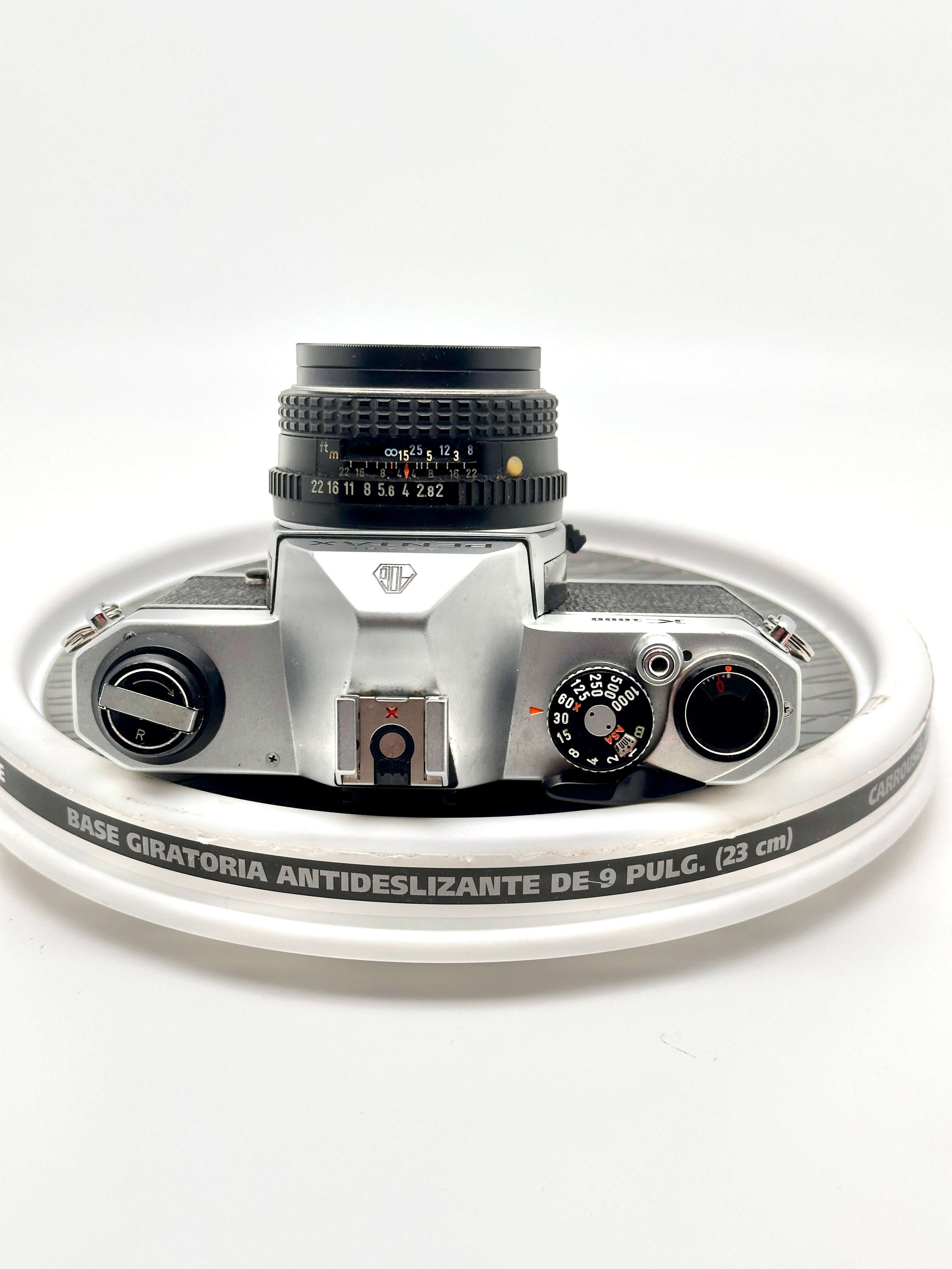 Pentax K1000 black 35mm film camera top view with 50mm f2 lens, showcasing vintage design and classic controls.