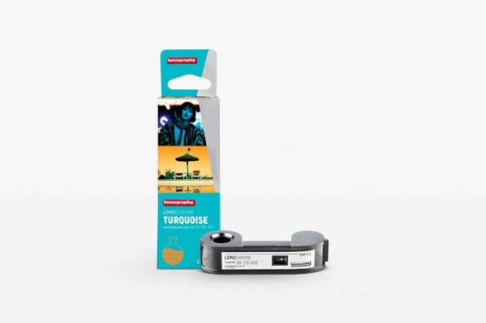 LomoChrome Turquoise 120 film by Lomography with packaging and camera.