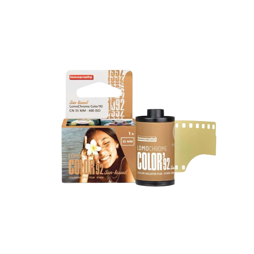 Lomography lomochrome color 92 sun-raised color negative film in a tan cardboard box with black and white text, featuring a smiling woman holding a flower.