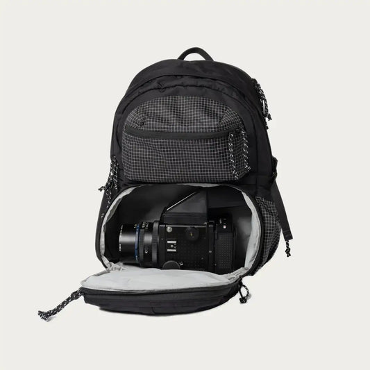 Open black Morro Convertible Backpack showing padded camera compartment for photography gear.