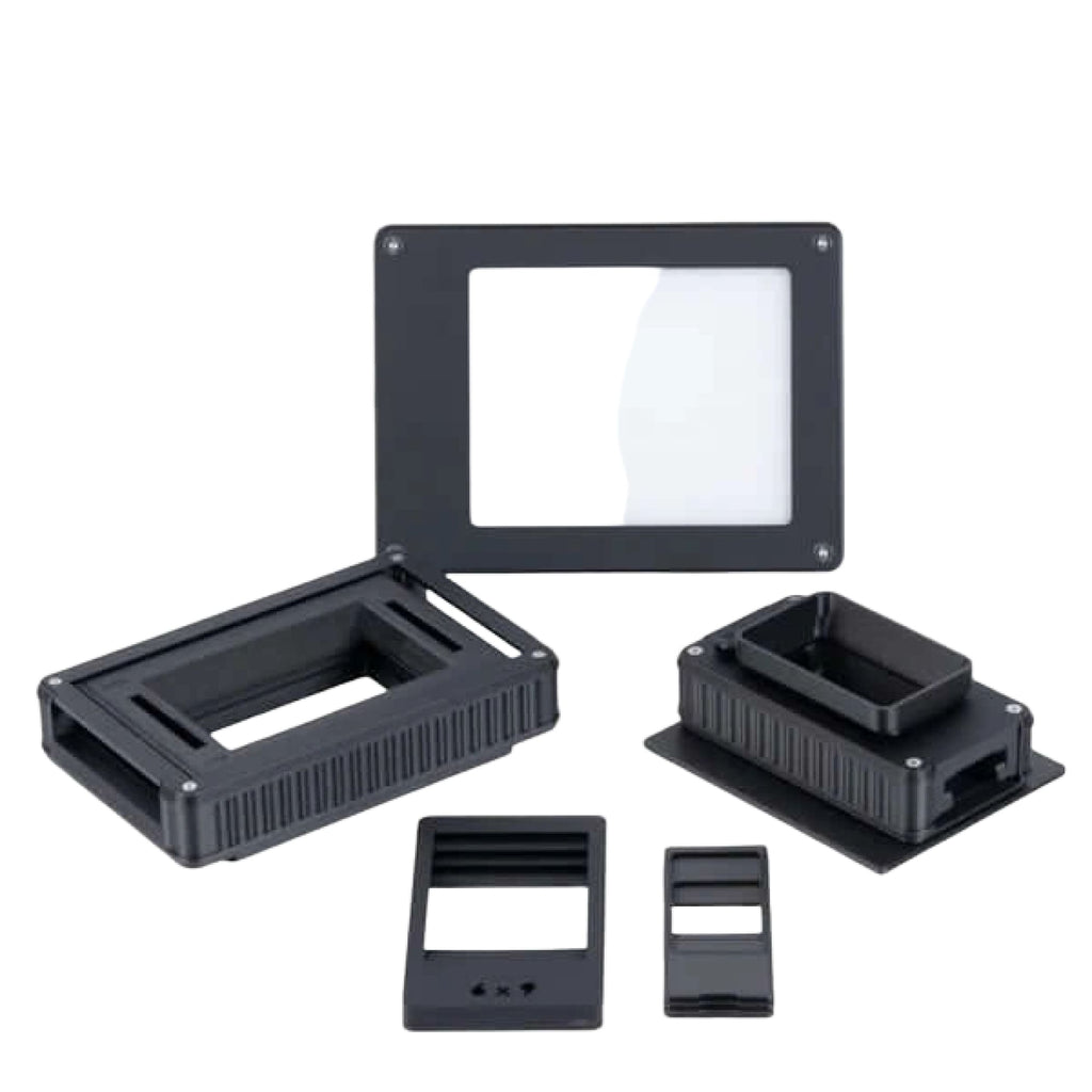 Black plastic smd component test fixture with rectangular slots and ridged sides.