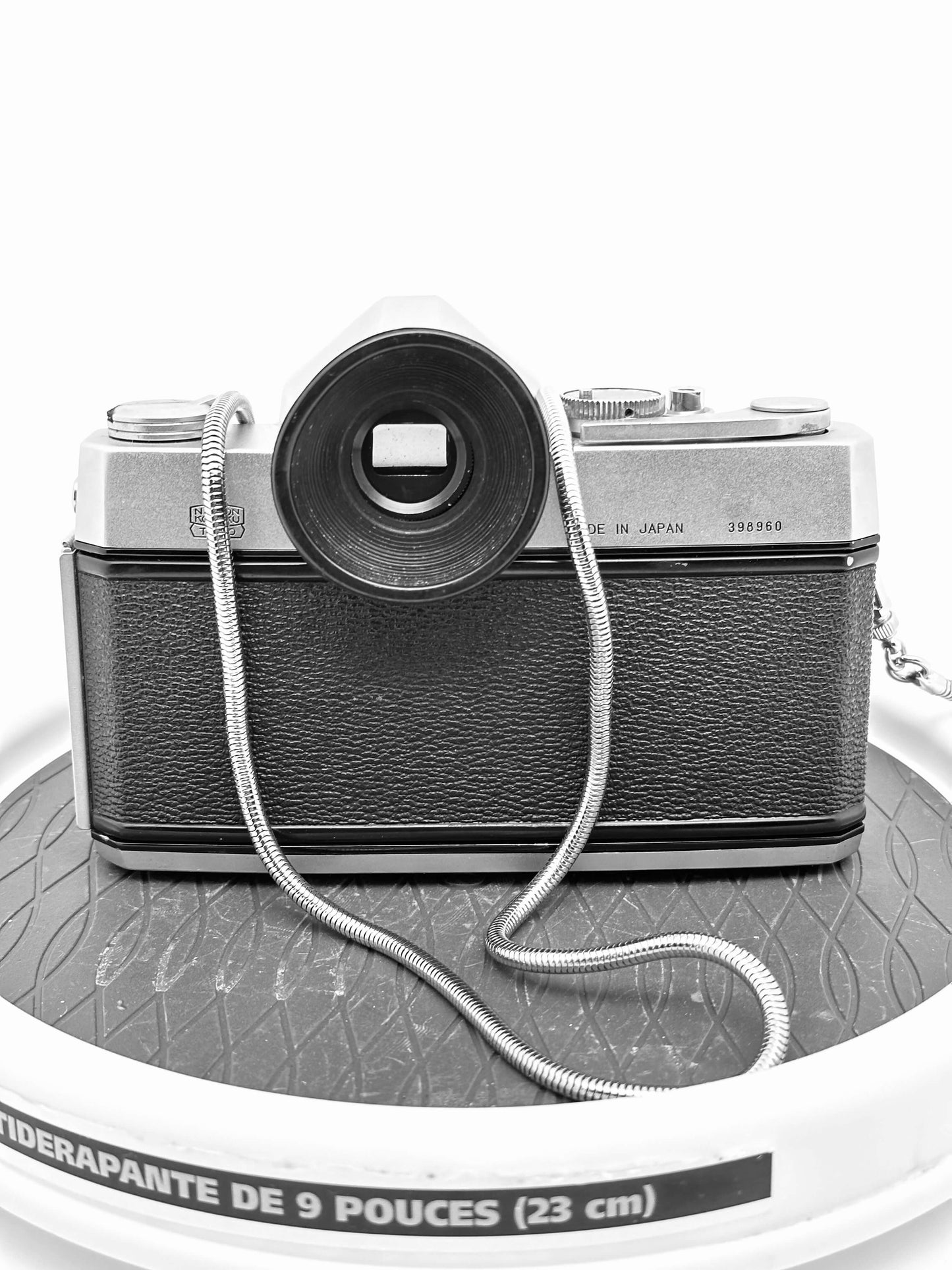 Nikkorex F 35mm film camera with lens, vintage design, showing wear, providing a classic photography experience.