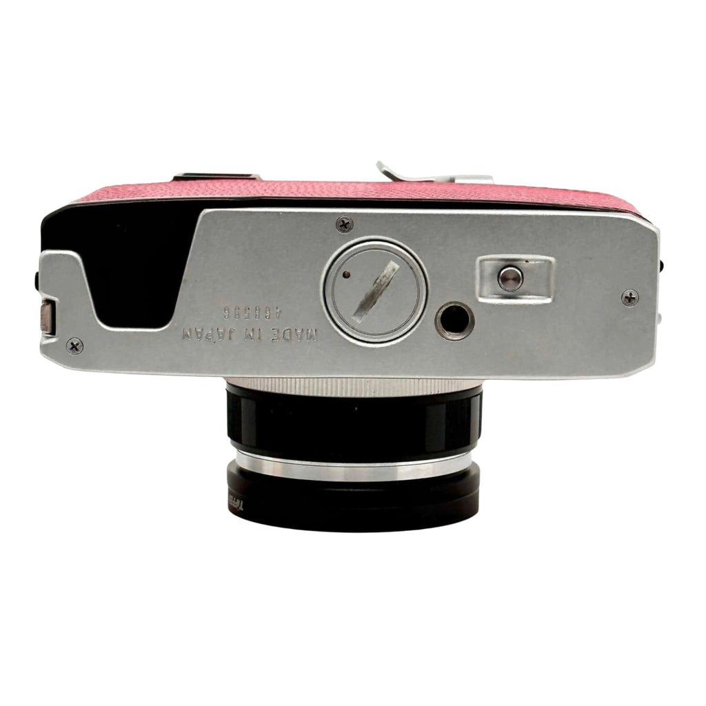 Pink textured leather top with silver metal body and black lens mount, featuring a vintage camera design.