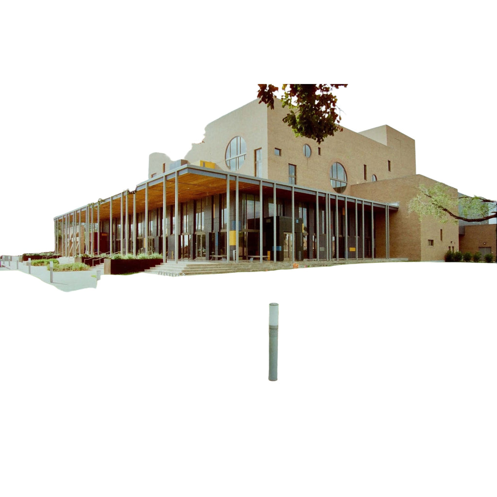 Modern beige brick building with large circular windows and a glass-enclosed entrance.