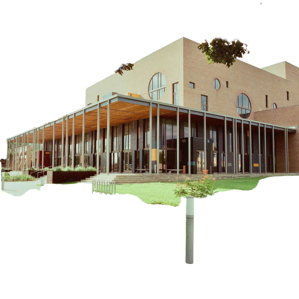 Modern brick building with large circular windows and a glass-enclosed entrance.