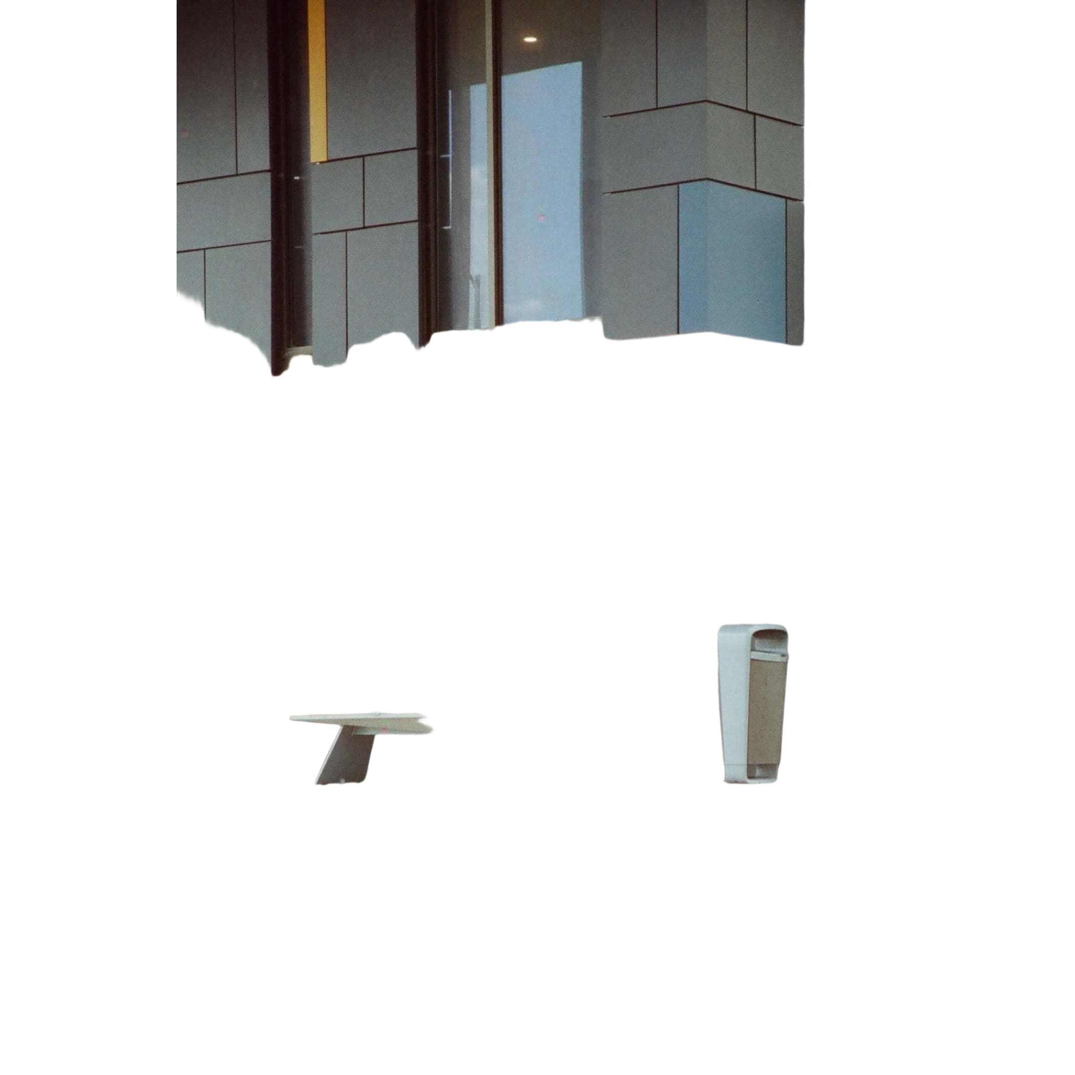 Modern minimalist bench with a sleek, light gray concrete surface and angular metal legs.