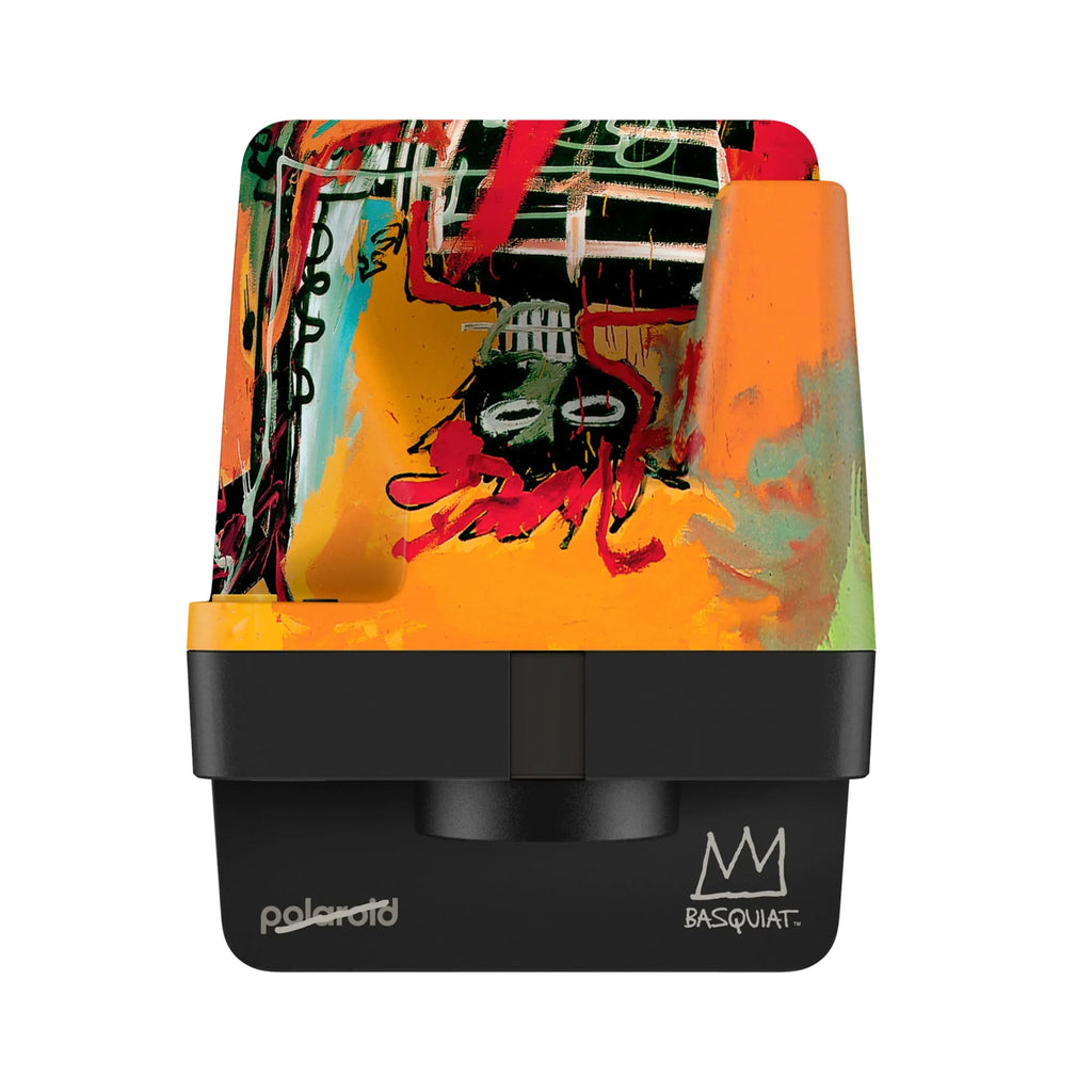 Polaroid instant camera featuring a vibrant, graffiti-style artwork with bold reds, oranges, and greens over a black base.