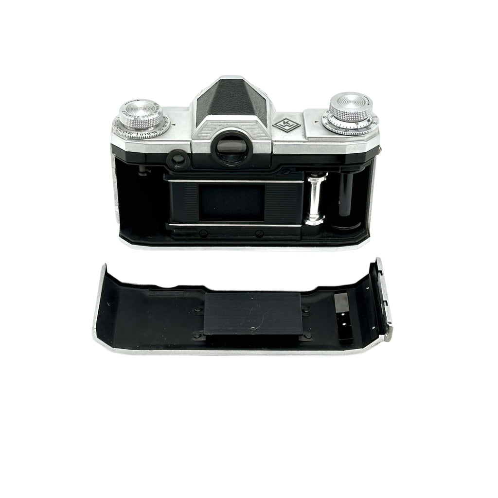 Silver and black kodak retina 35 film camera body with exposed internal components.