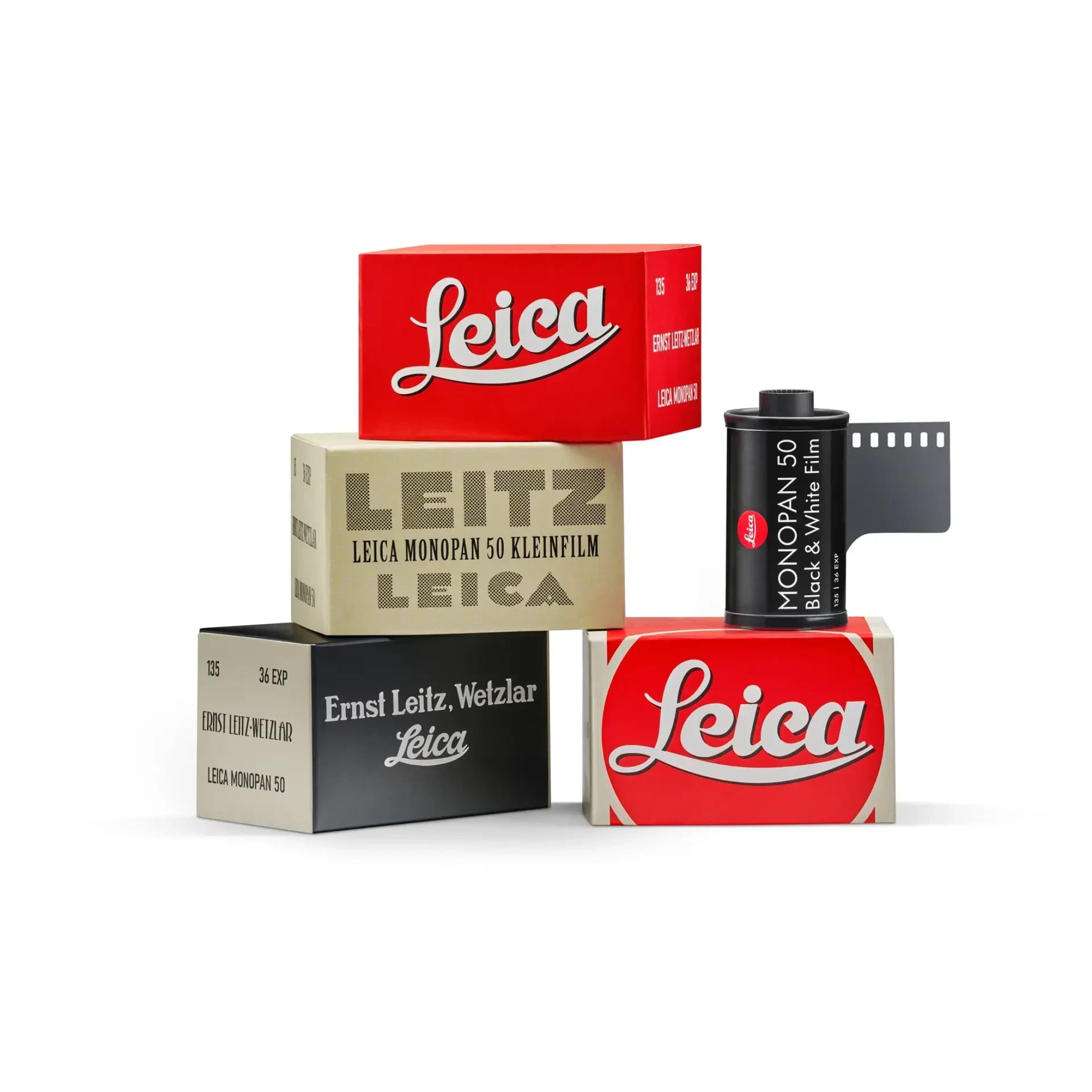 Red and beige leica film boxes with black-and-white photographic film canister.