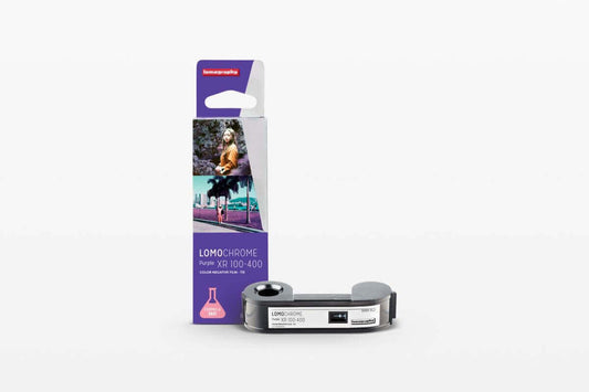 LomoChrome Purple XR 100-400 film packaging with film roll on white background
