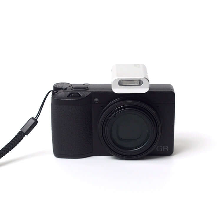 Reflx Lab Mini Flash V2 mounted on a compact camera enhancing photography capabilities.