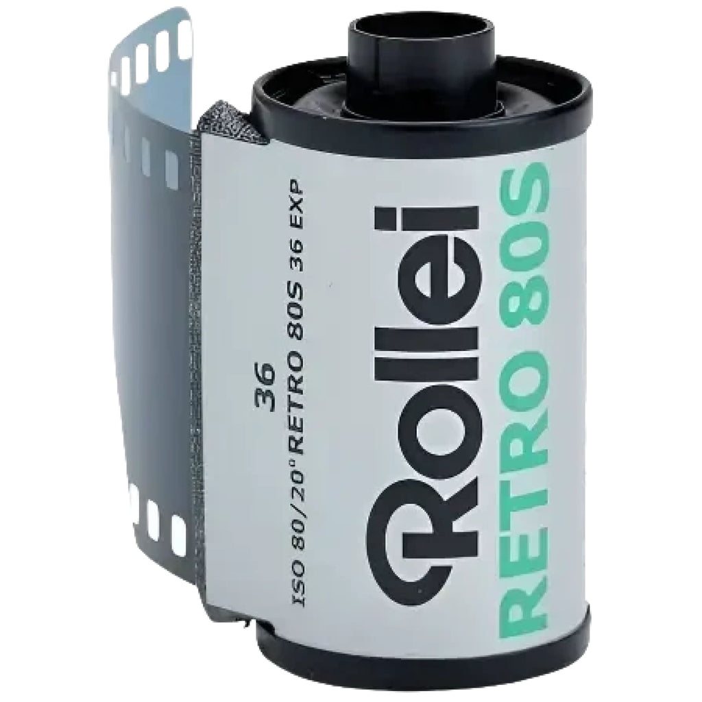A black and white rollei retro 80s film roll with a silver label, featuring green text for the model name.