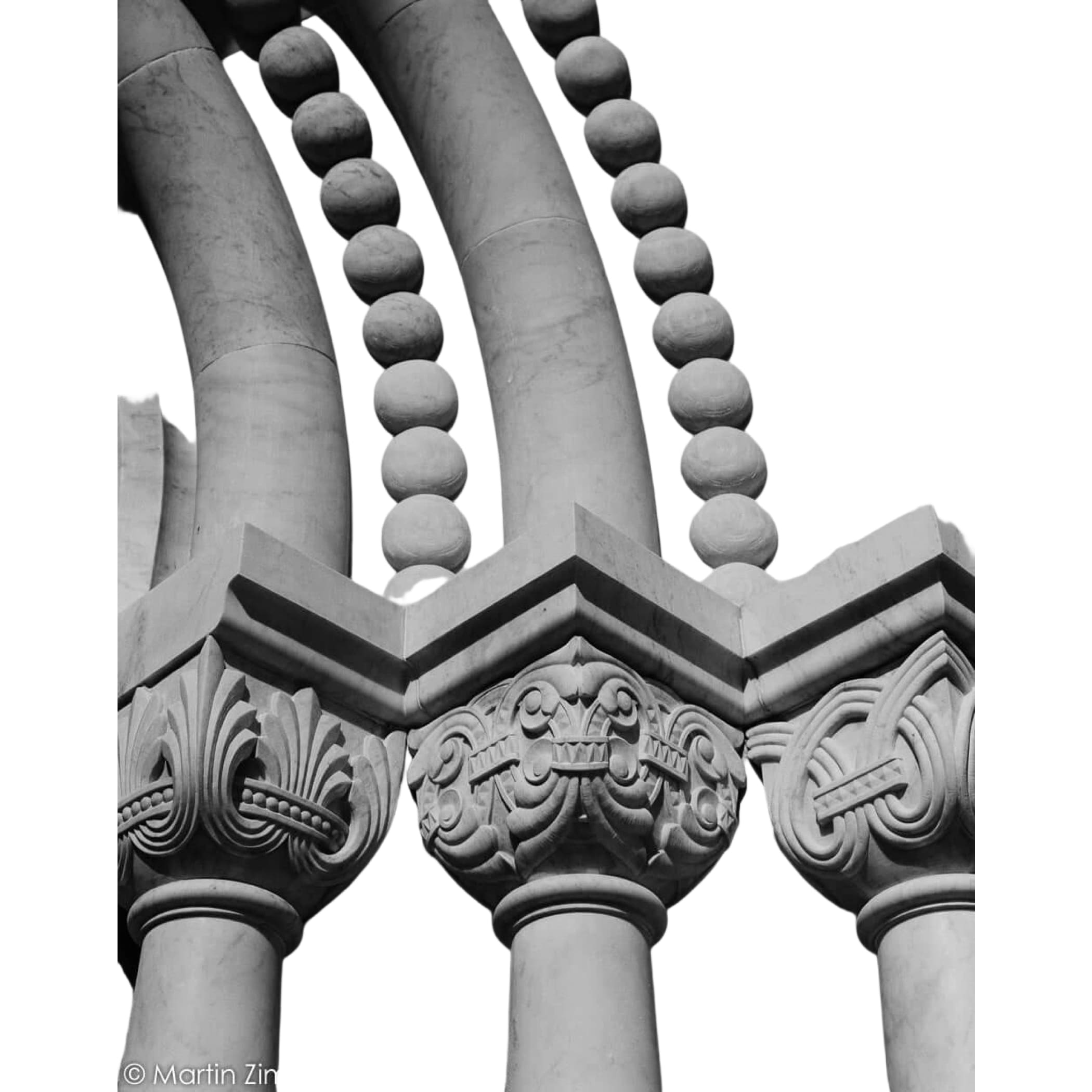 Carved stone columns with ornate capitals and spherical decorative elements.