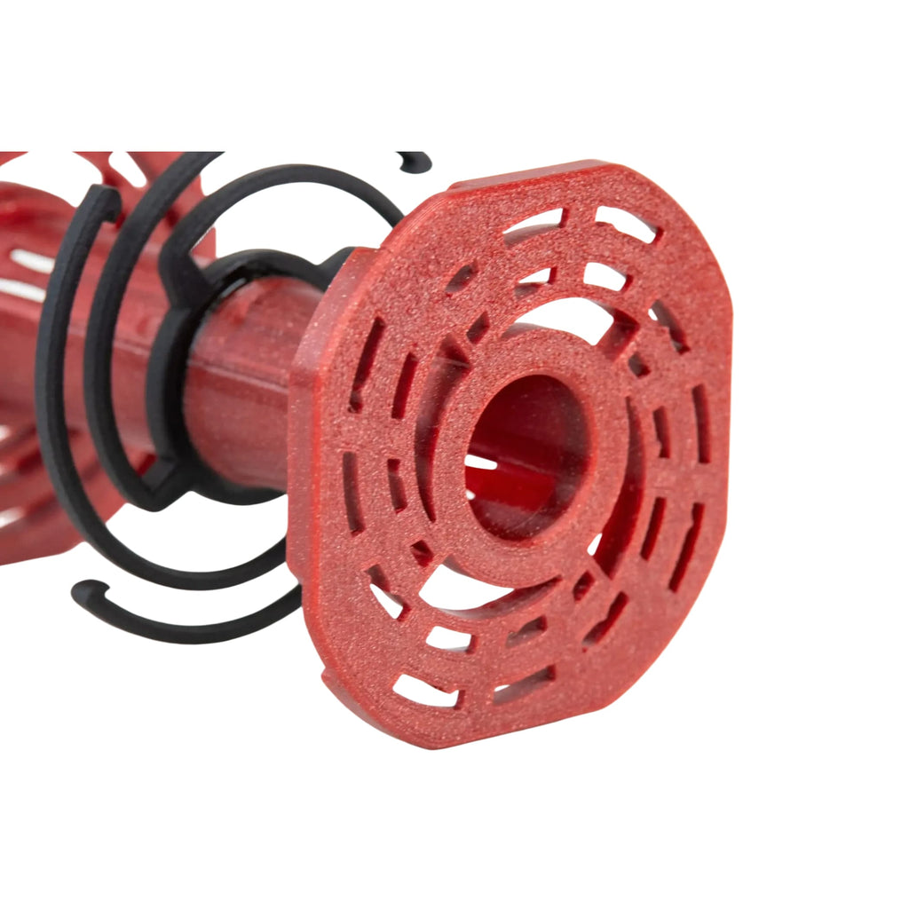 Red plastic spool with a geometric, perforated design and black spiral bands.