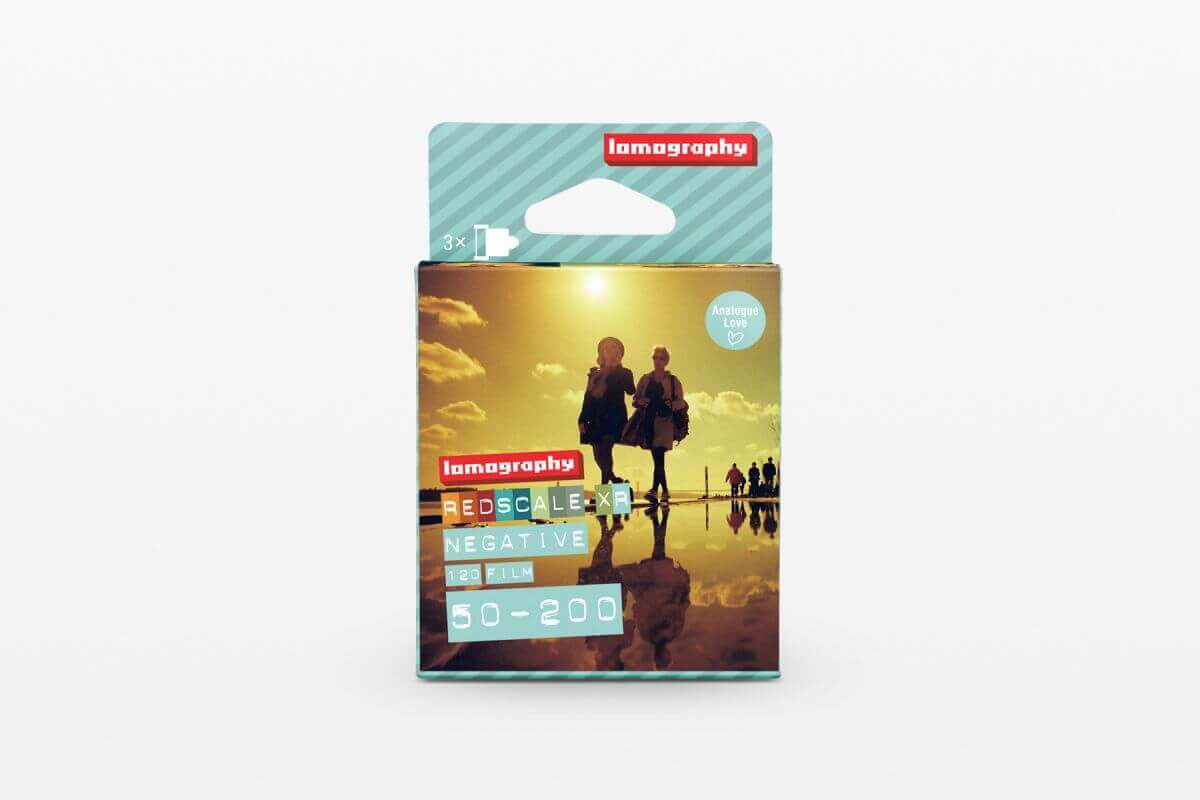 "Lomography Redscale Negative 50-200 film in packaging with silhouetted people at sunset on the cover"