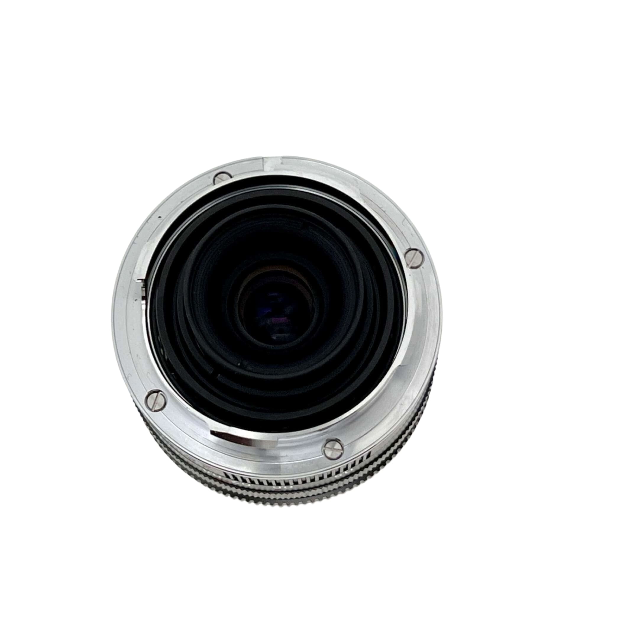 Silver-bodied camera lens with a textured focus ring and black glass elements.