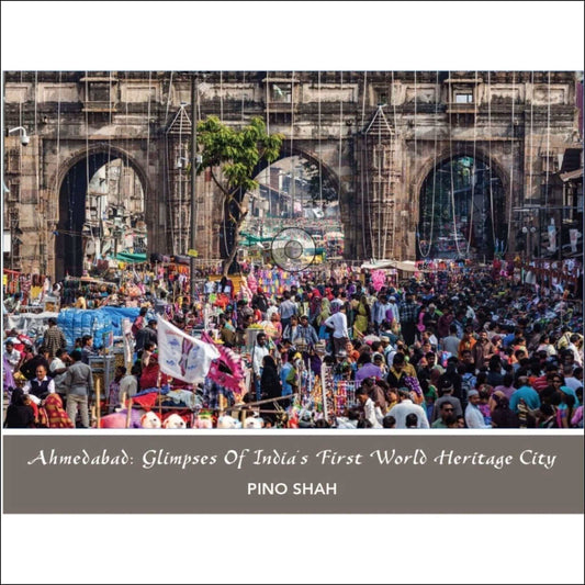 Busy street market scene at a historic archway in Ahmedabad, showcasing the vibrancy of India's First World Heritage City.