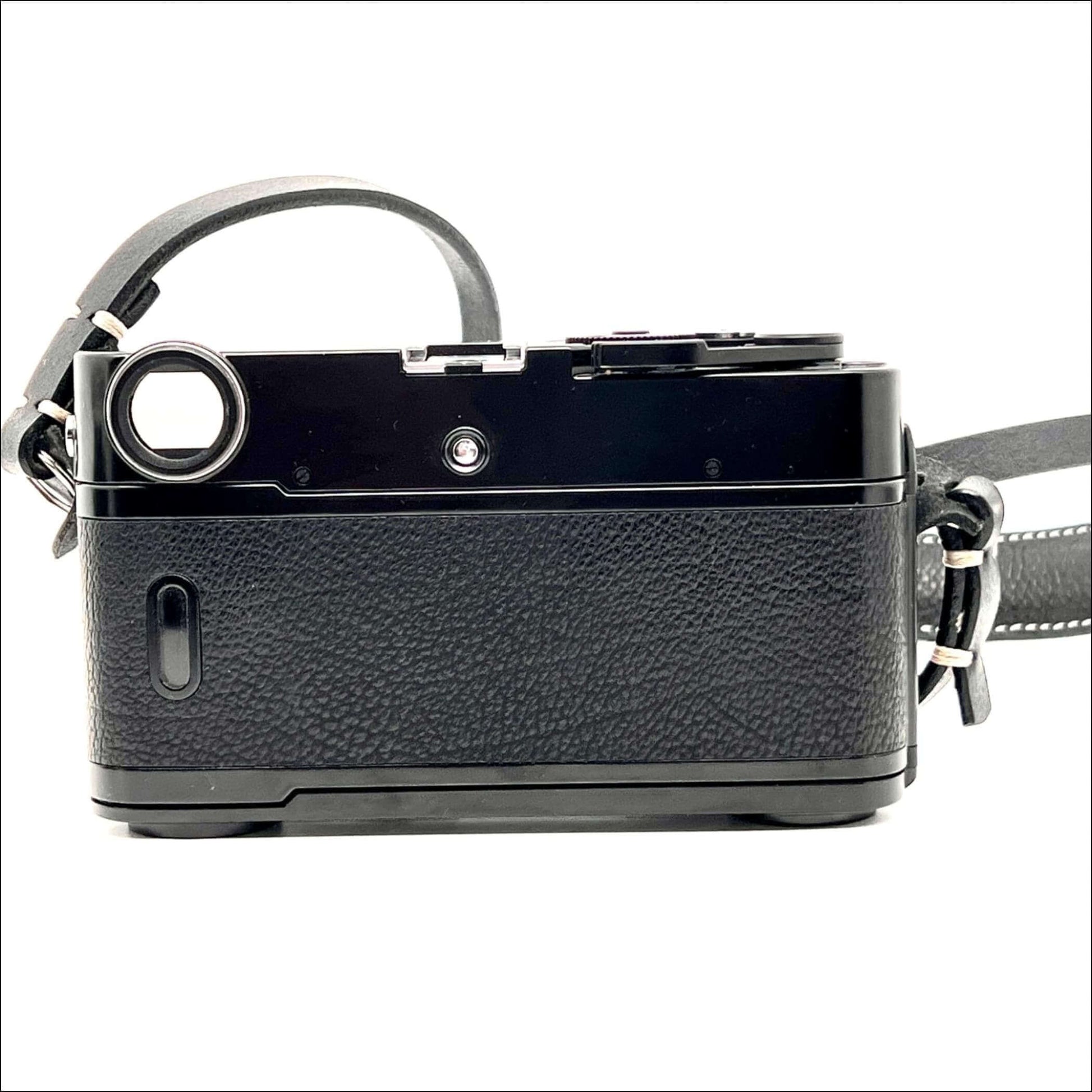 Back view of used Zeiss Ikon ZM 35mm film camera body in black with strap, compatible with Leica M mount lenses, featuring a built-in light meter