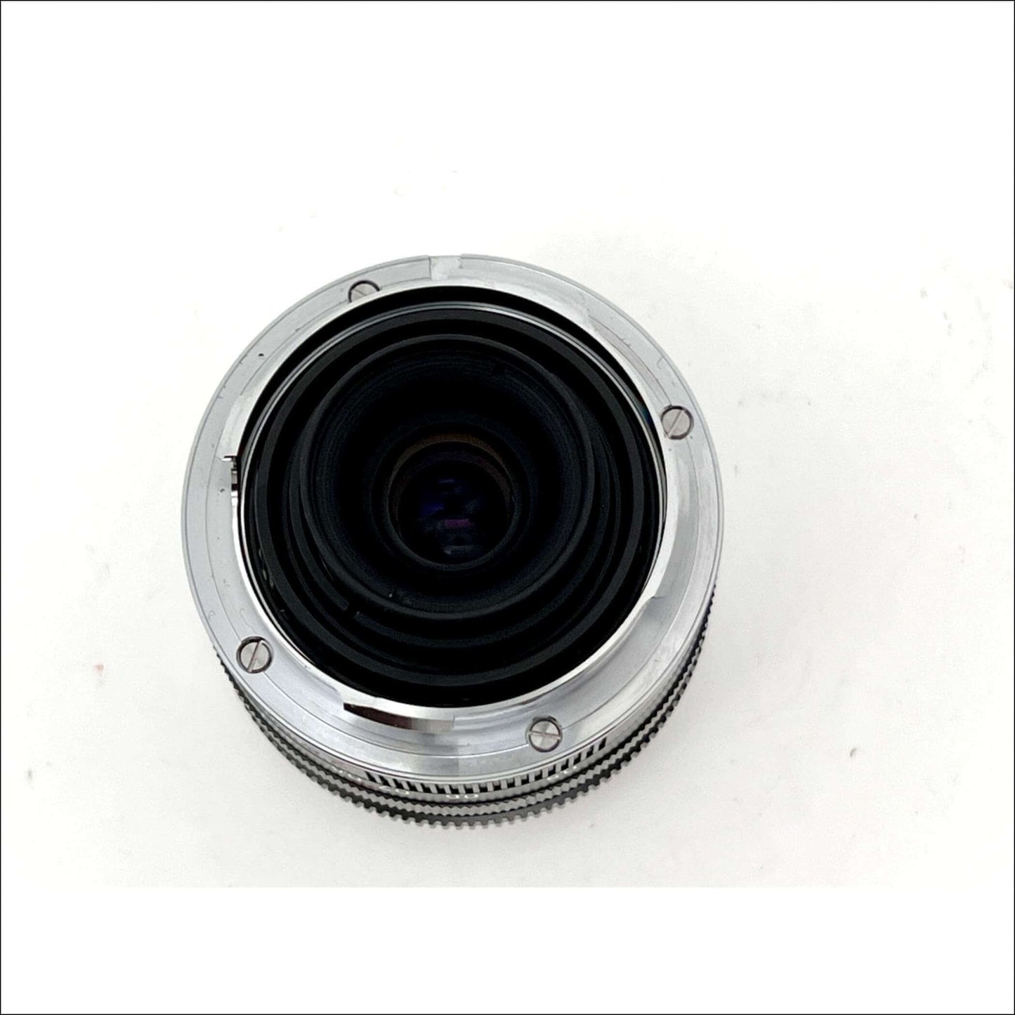 Close-up of a camera lens on a white background.