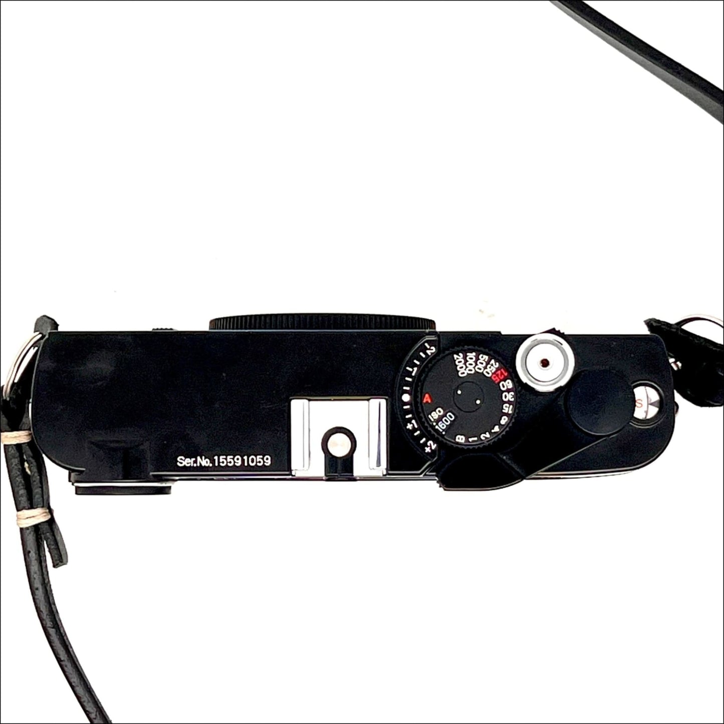 Top view of a vintage black camera with dials and controls on a white background