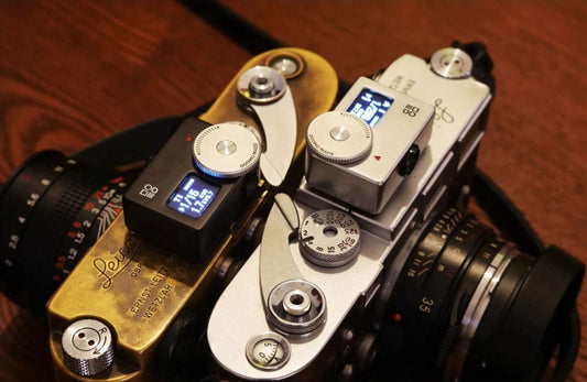 Doomo Meter S OLED light meter displayed on vintage film cameras for accurate exposure measurement.