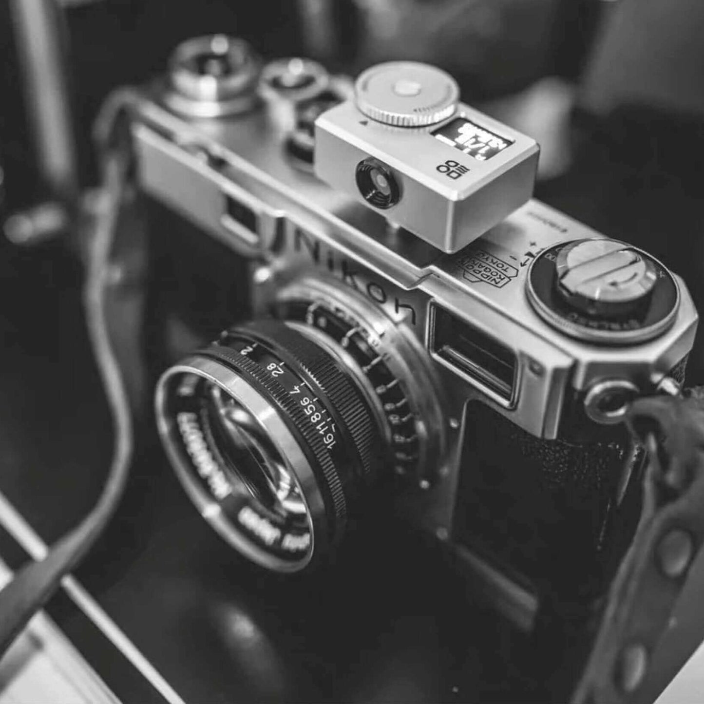 Vintage Nikon film camera in black and white close-up view