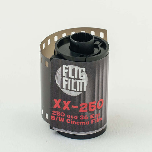 35mm black and white cinema film roll XX-250 with 250 ASA and 36 exposures standing on a white background.