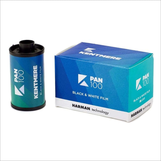 Kentmere PAN 100 black and white film roll next to its blue packaging from Harman Technology